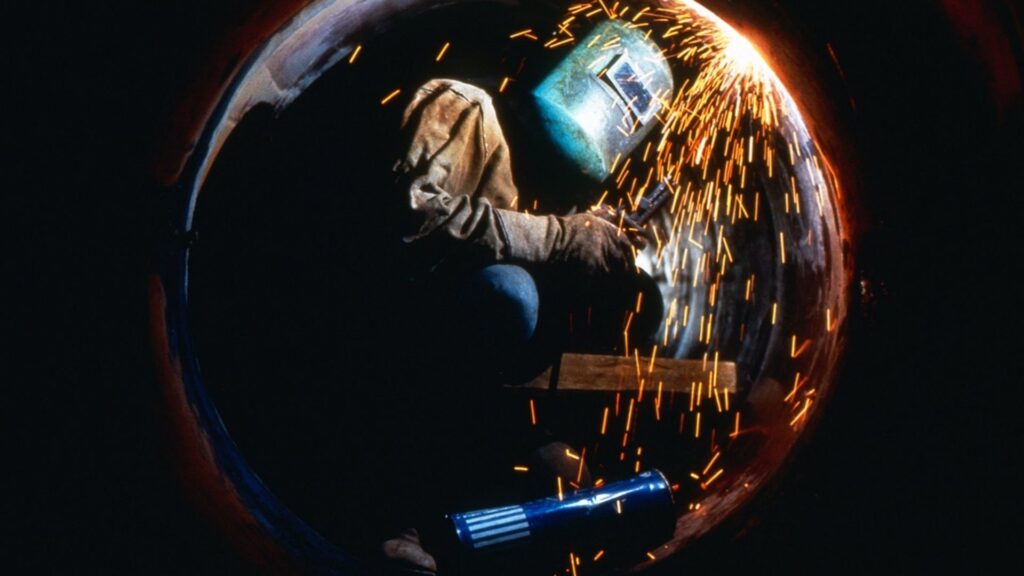 Picture of a pipe welder working,