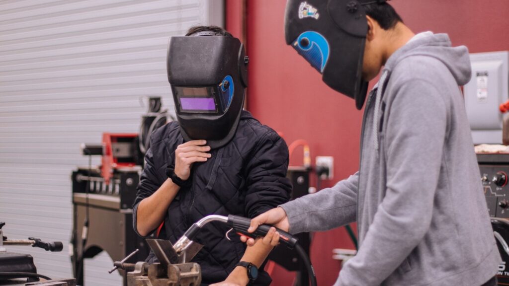 Picture of students working on their welding degree,