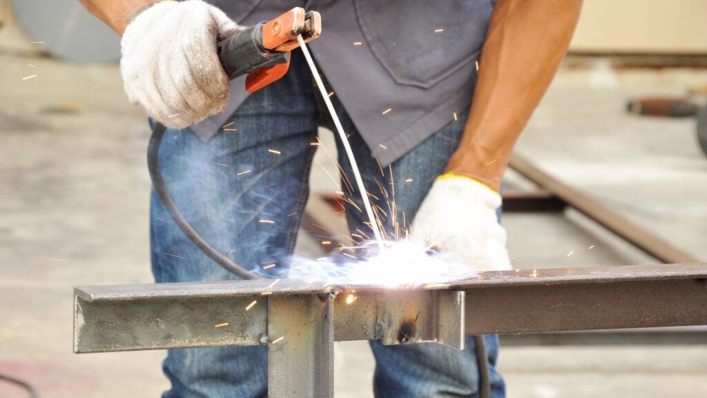 Picture of a man stick welding.